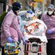 Fire Department of New York medical staff attend to an elderly person experiencing difficulty breathing outside of an apartment building on April 20, 2020, in New York City.